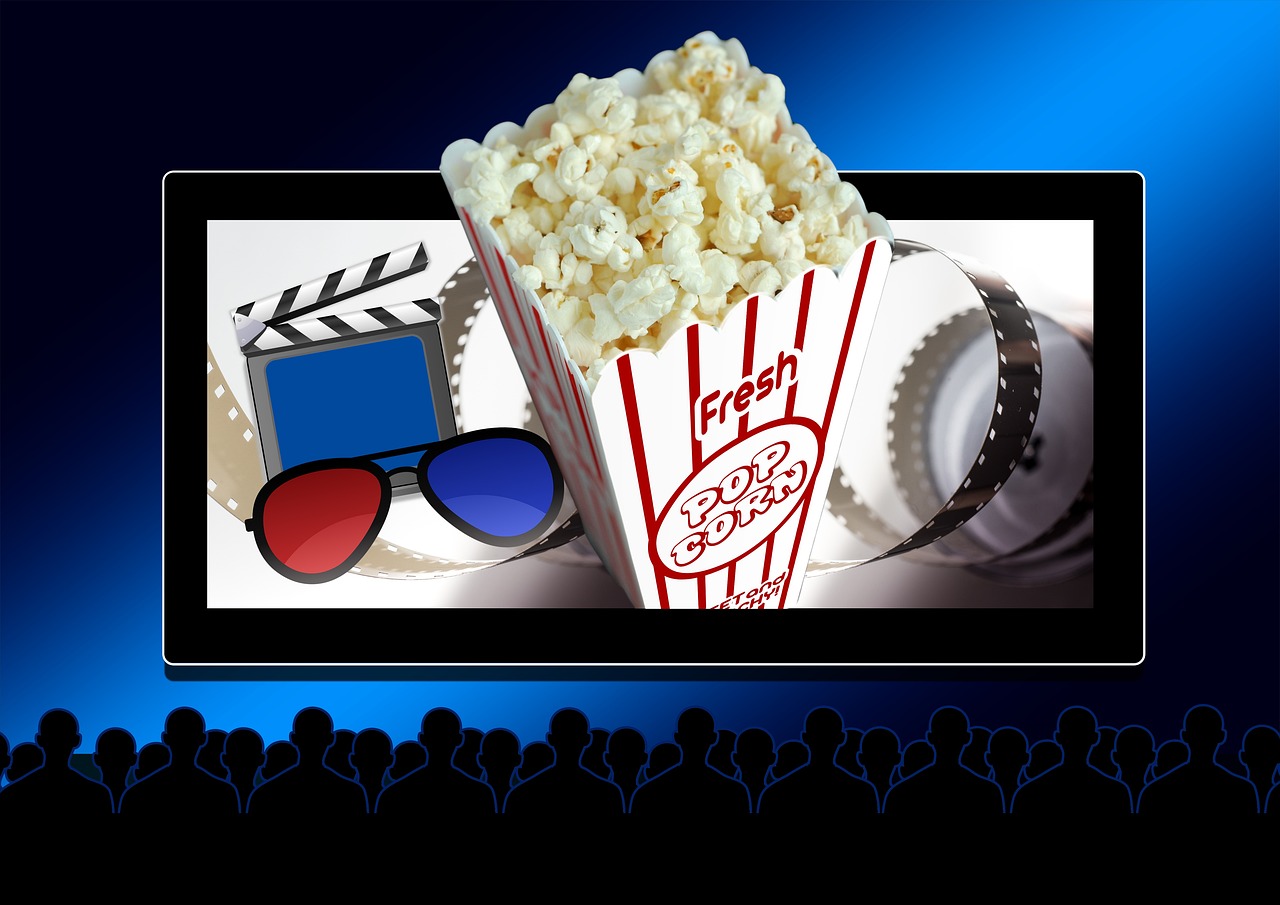 Spectatori în sala de cinema, văzuți din spate, în fața ecranului luminat